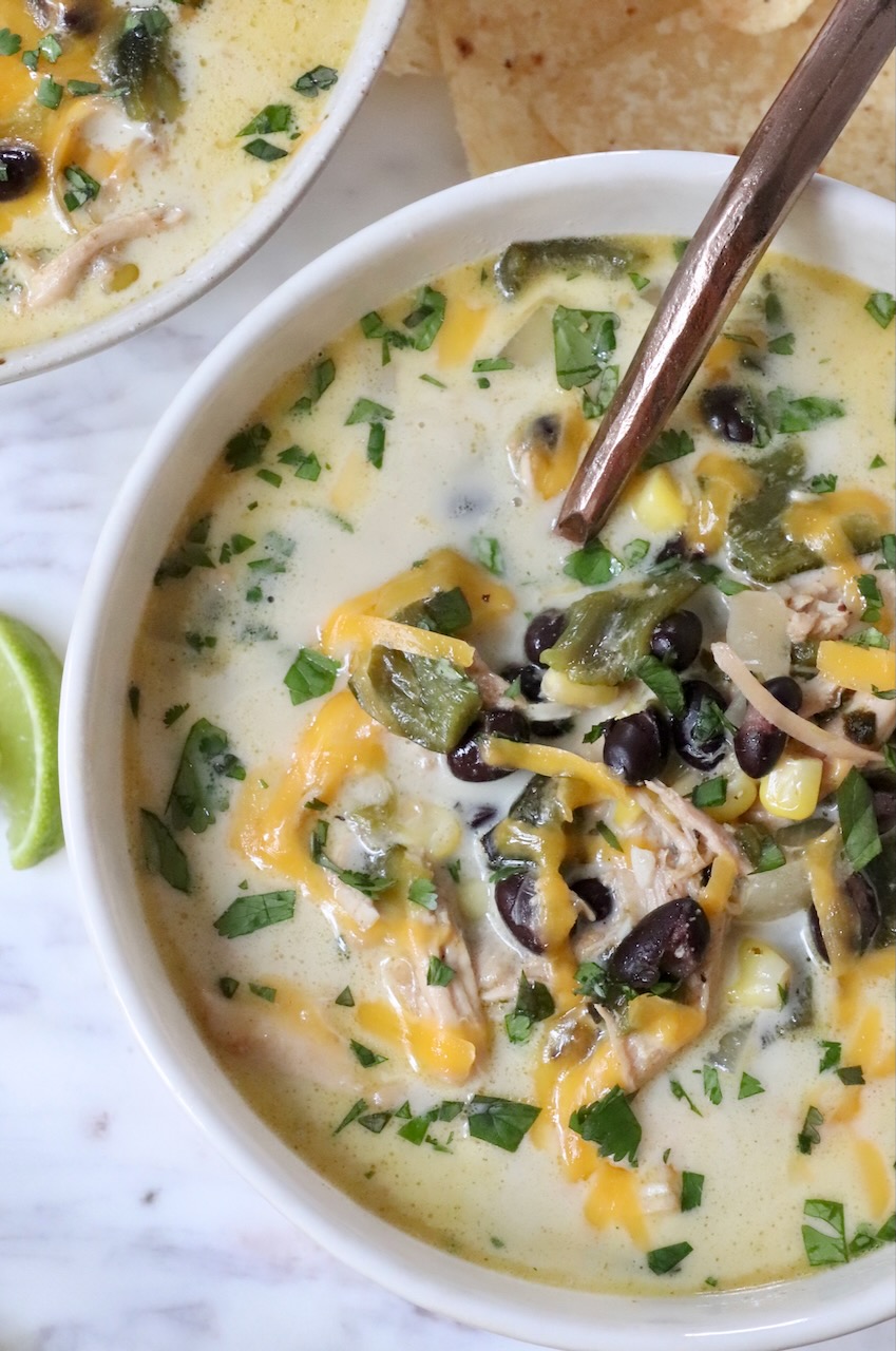 chicken poblano soup in a bowl with a spoon