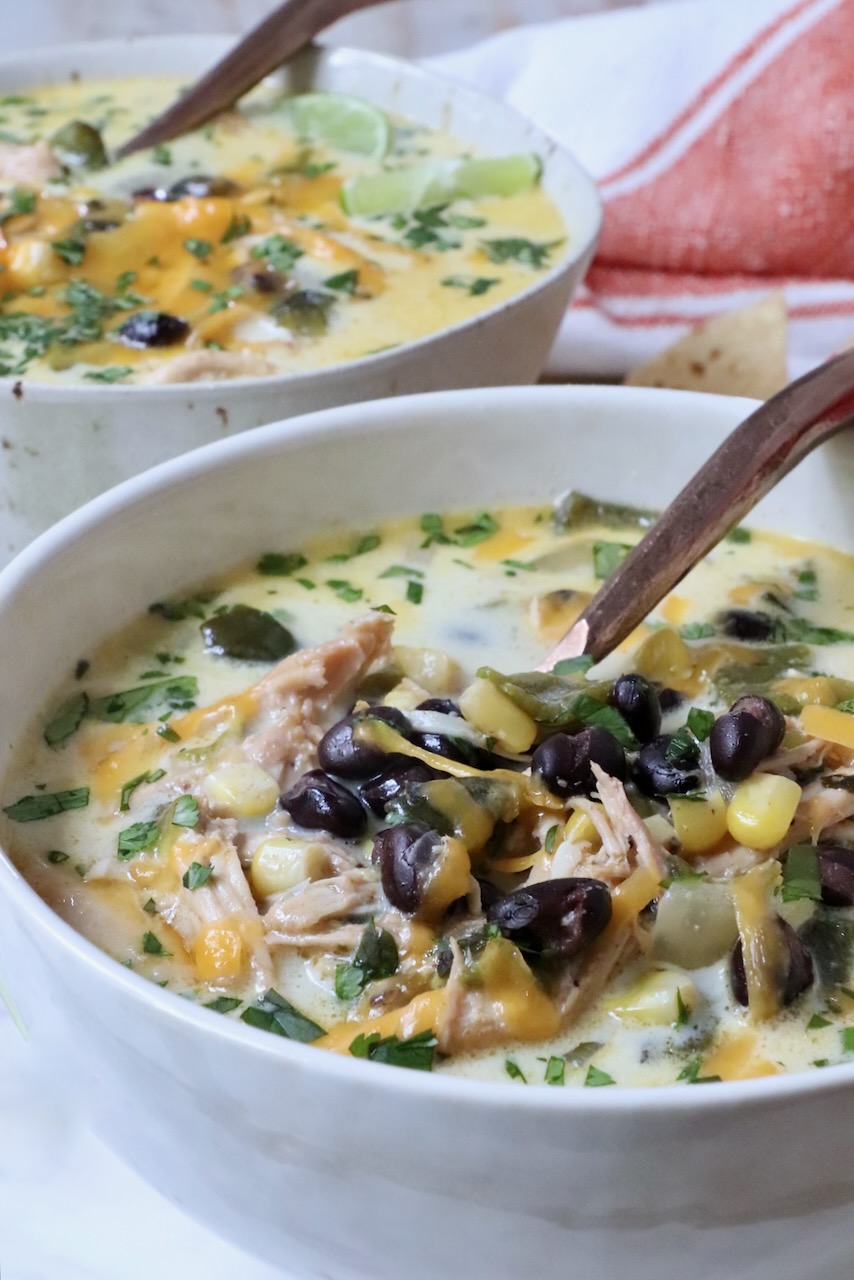 black bean and chicken poblano soup in a bowl with a spoon