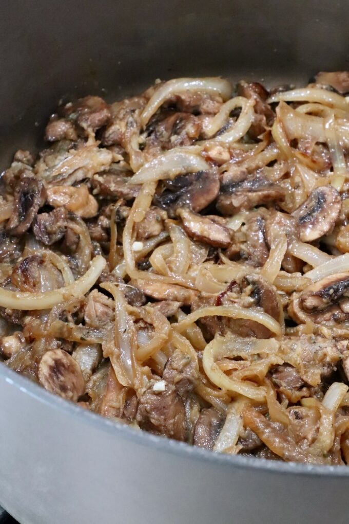 sliced onions and mushrooms combined with flour and butter in a large pot