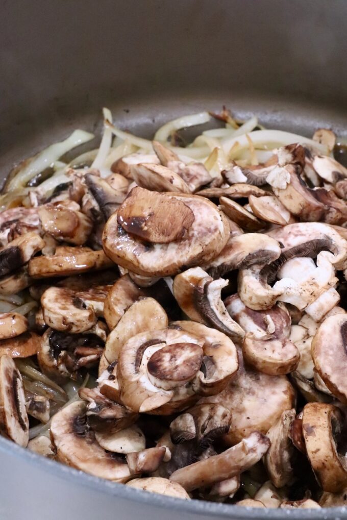 sliced onions and sliced mushrooms in a large pot