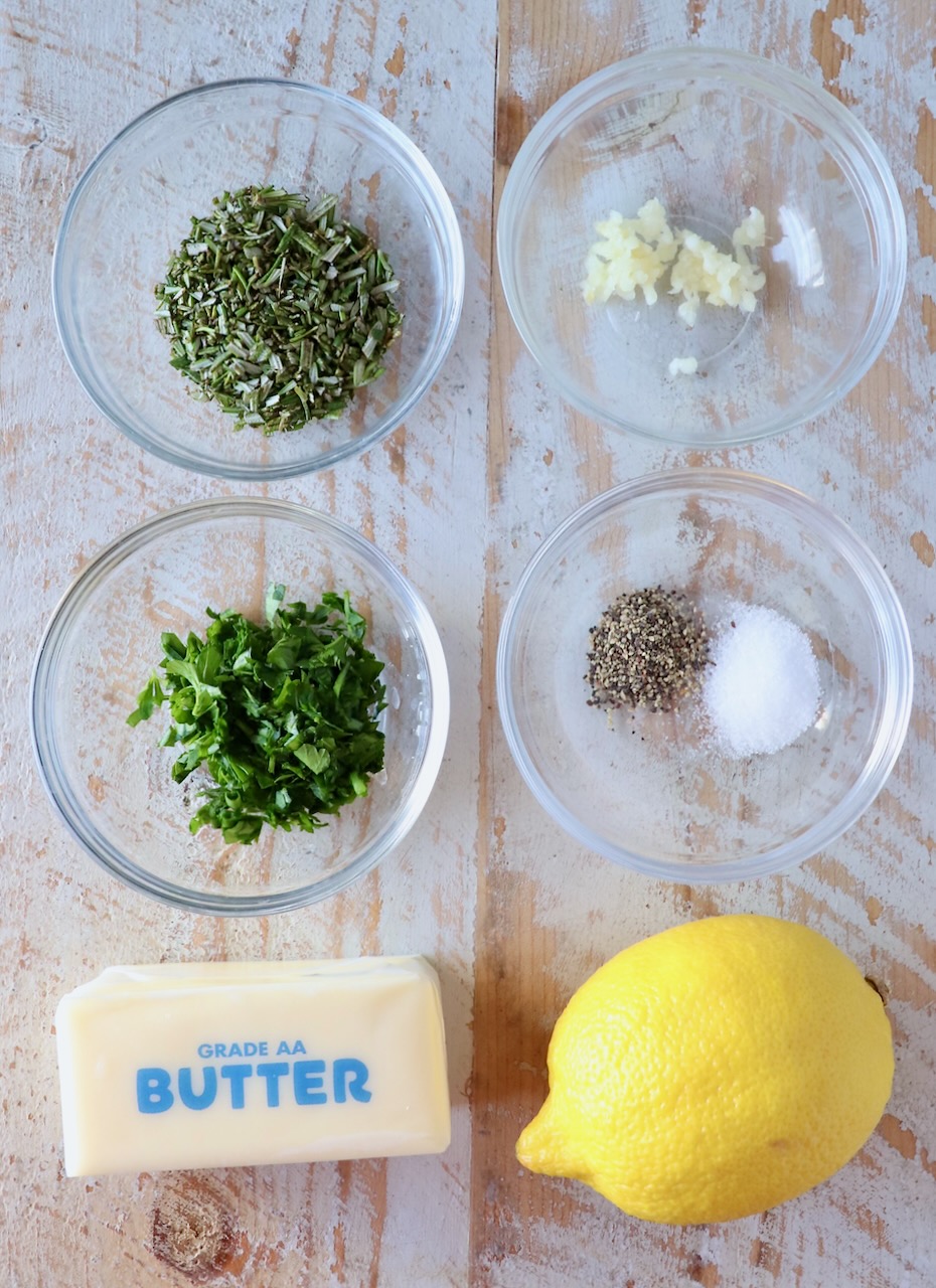 ingredients for compound butter on a white wood board