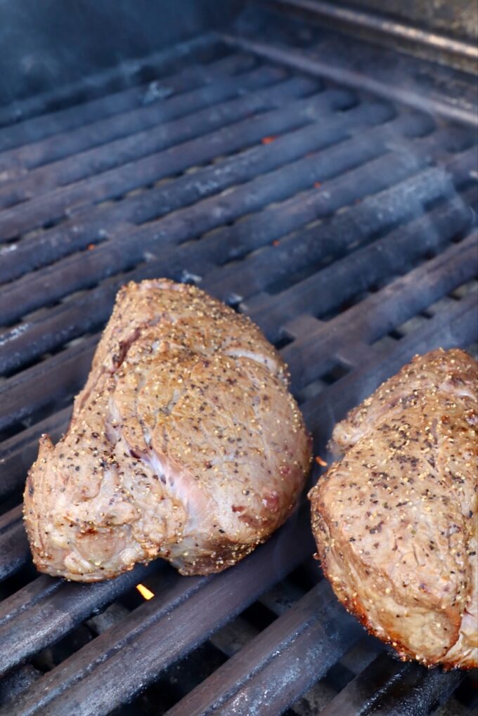 seasoned filet mignon steaks on a grill