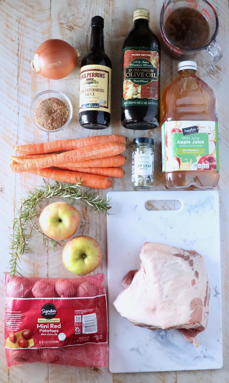 ingredients for pork roast on a white wood board