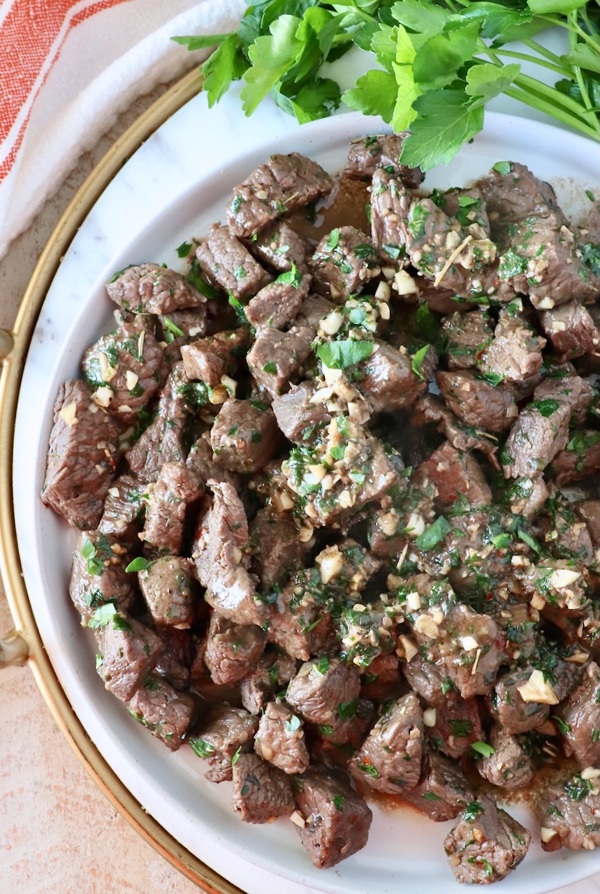 cooked steak bites piled up on a plate