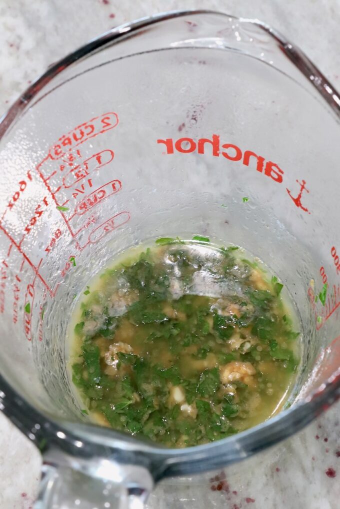 garlic, parsley, and melted butter in a glass measuring cup