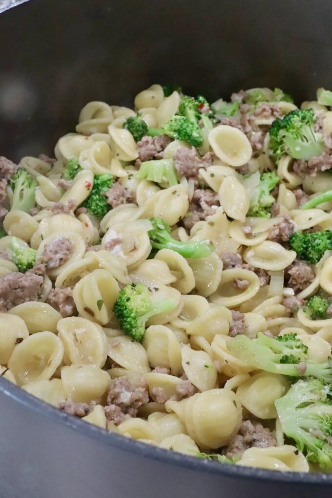 cooked pasta with broccoli and sausage in a large pot