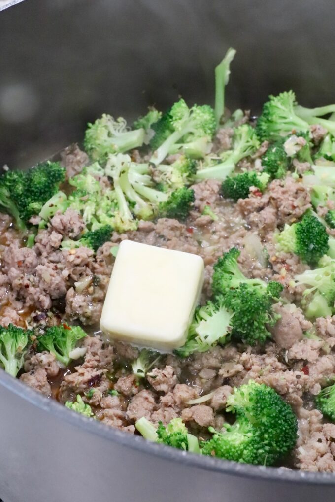 cooked sausage and broccoli in a large pot with butter