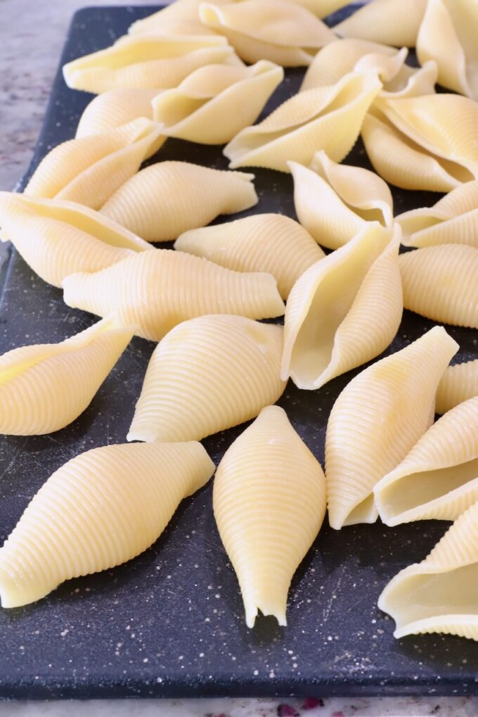 cooked jumbo pasta shells on a cutting board