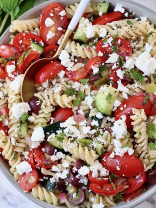 pasta salad in a bowl with a spoon