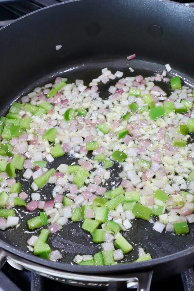 diced onion and bell pepper in a skillet on the stove