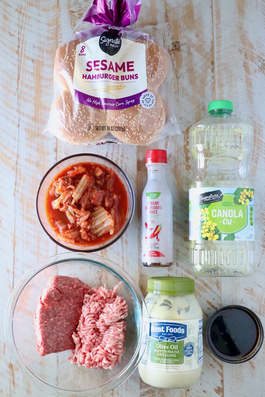 ingredients for korean bbq burgers on a white wood board