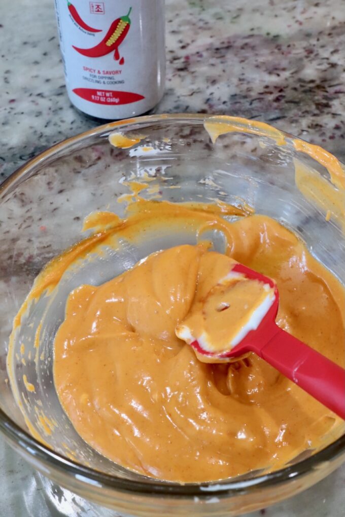 gochujang mayonnaise in a glass bowl with a red spatula