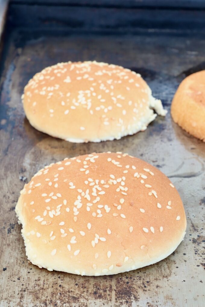 sesame seed buns on a griddle