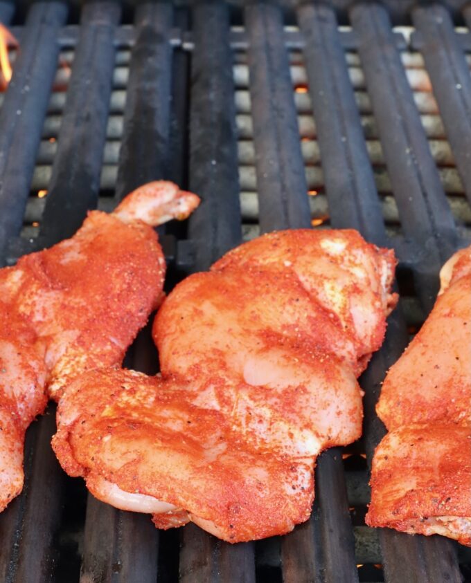 seasoned chicken thighs on a grill