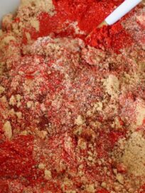 brown sugar and spices mixed together in a bowl with a spoon