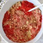 brown sugar and spices mixed together in a bowl with a spoon