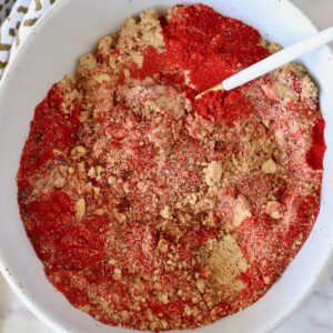 brown sugar and spices mixed together in a bowl with a spoon