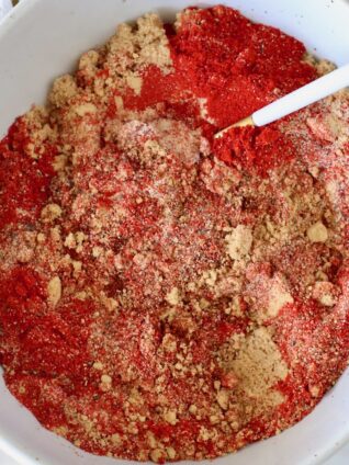 brown sugar and spices mixed together in a bowl with a spoon