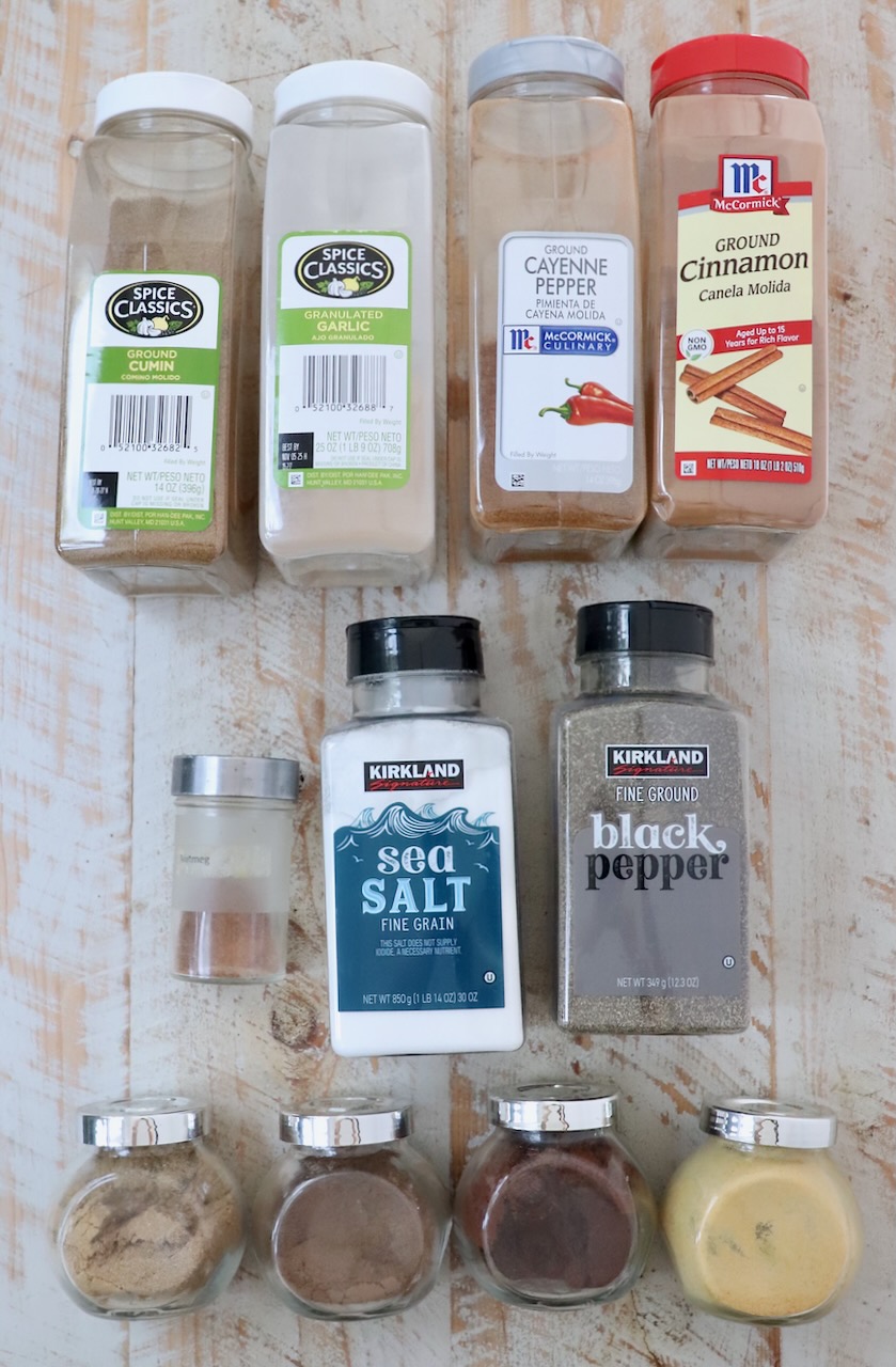 ingredients for shawarma seasoning on a white wood board