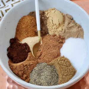 spices separated in a bowl with a small spoon