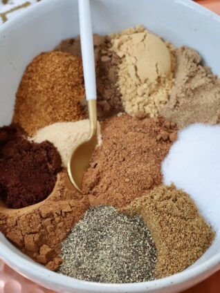 spices separated in a bowl with a small spoon