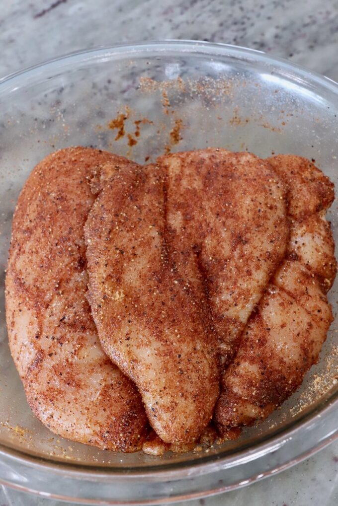 seasoned chicken breasts in a glass bowl