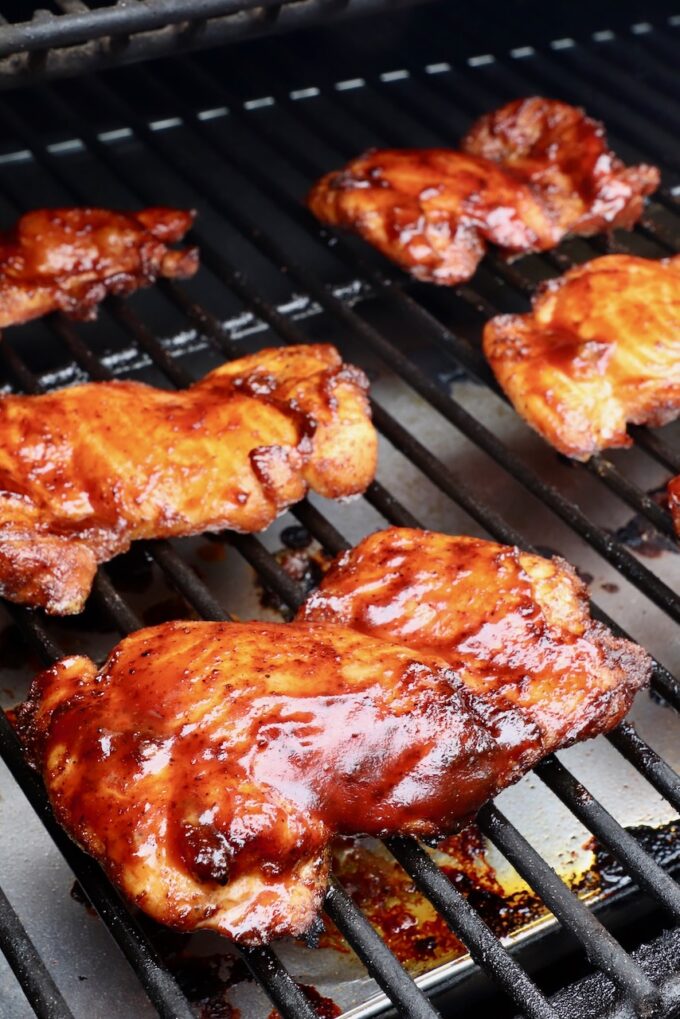 bbq sauce glazed smoked chicken thighs on a smoker