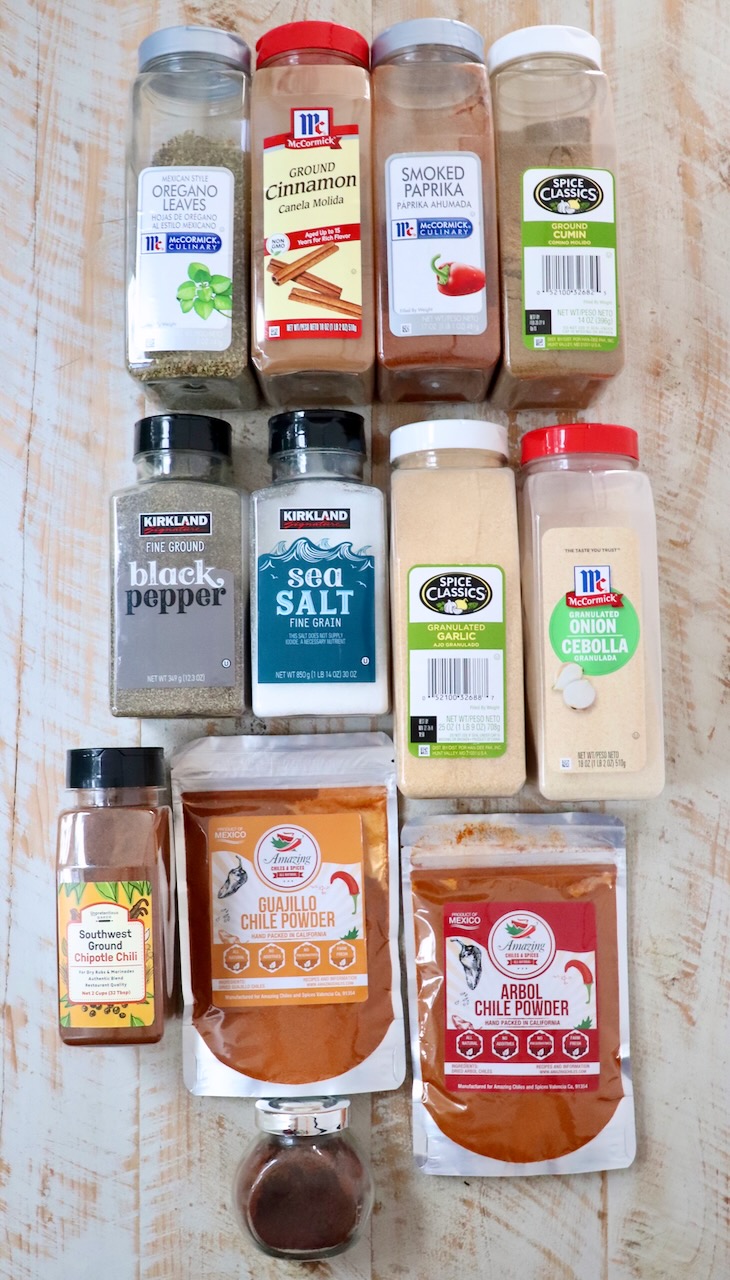 ingredients for birria seasoning on a white wood board