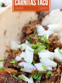 shredded pork in tortillas on plate, topped with diced onions and fresh chopped cilantro
