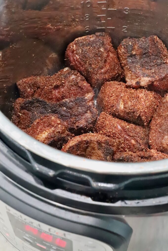seasoned, seared pieces of beef in an Instant Pot