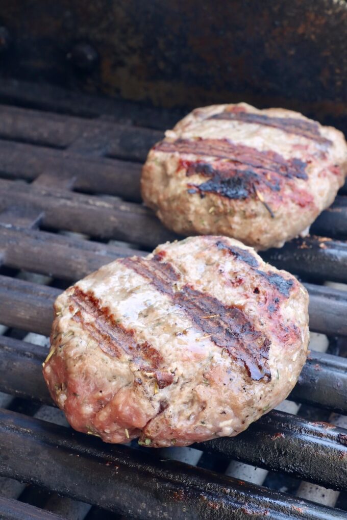 cooked lamb burger patties on a grill