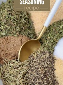 dried herbs and spices separated in a bowl with a spoon