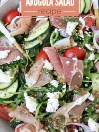 salad in a bowl with prosciutto, cucumber, tomatoes and feta cheese