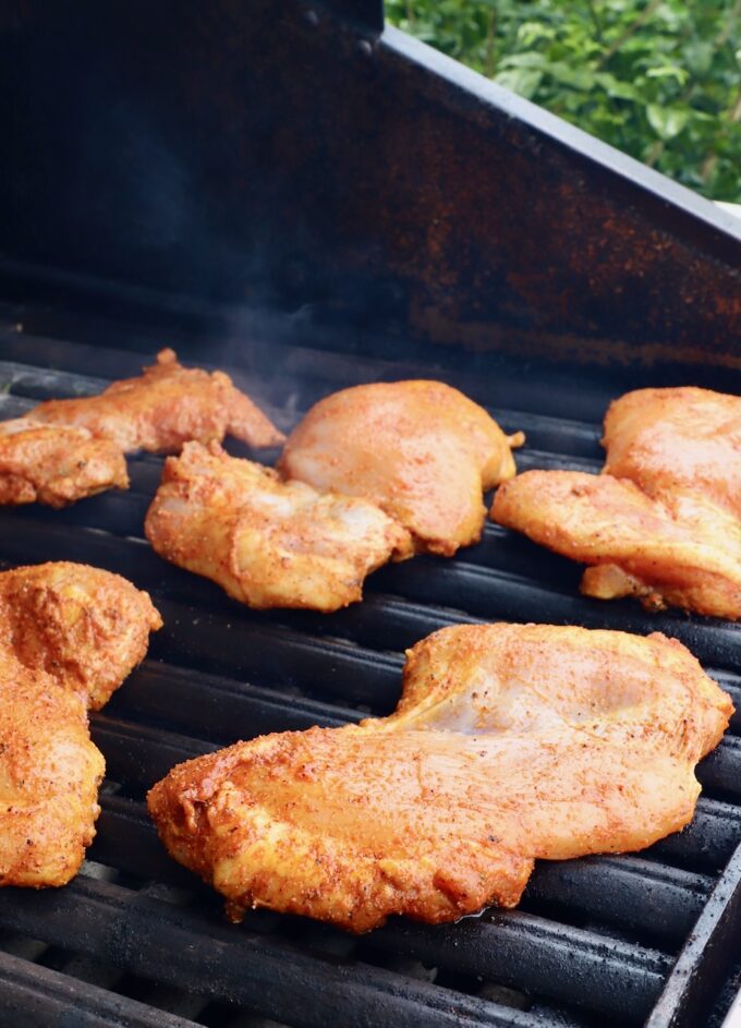 seasoned chicken thighs on a grill