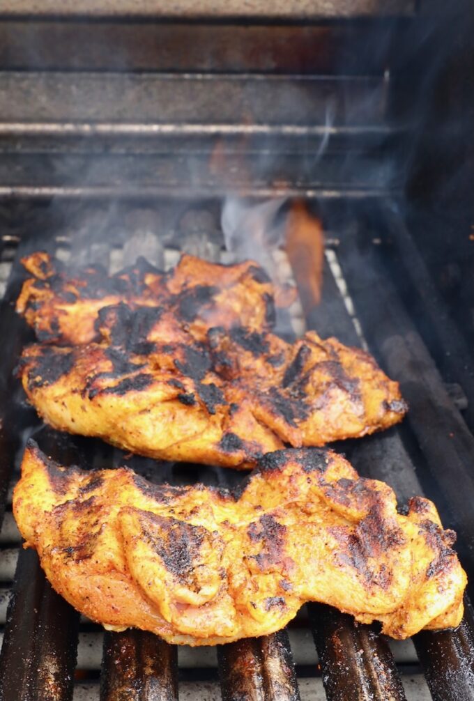 grilled, marinated chicken thighs on a grill
