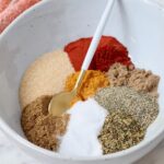 spices separated in a bowl with a spoon