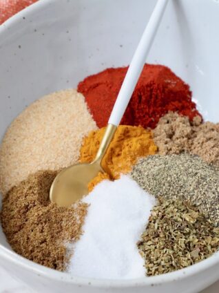 spices separated in a bowl with a spoon