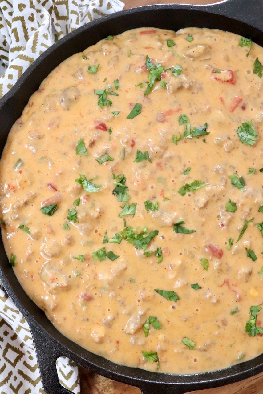 smoked queso in a skillet topped with fresh cilantro