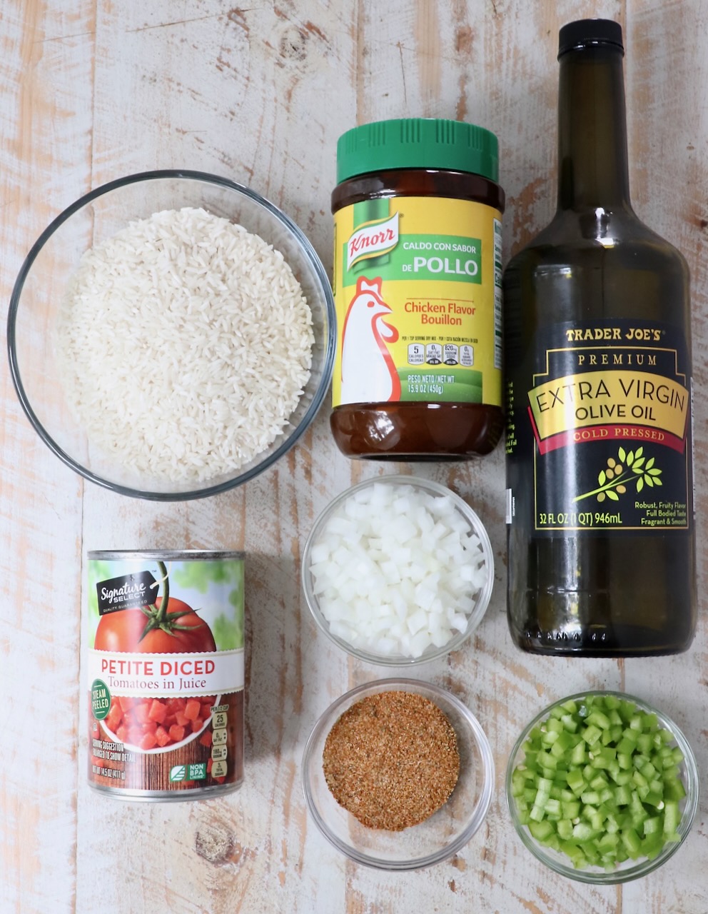 ingredients for yellow rice on a white wood board