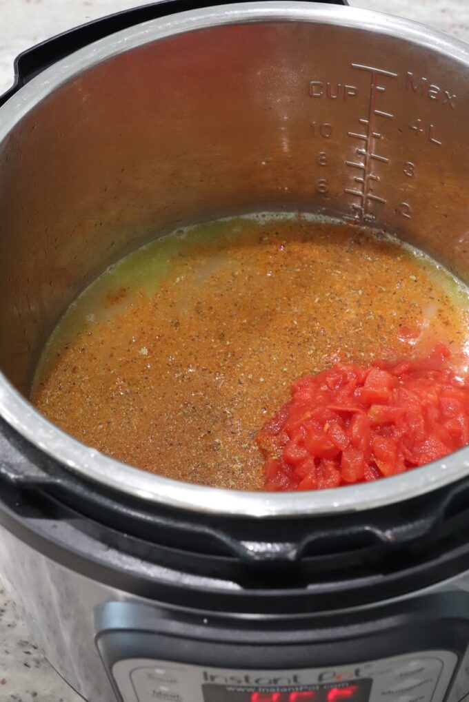 rice, seasoned broth and diced tomatoes in an Instant Pot