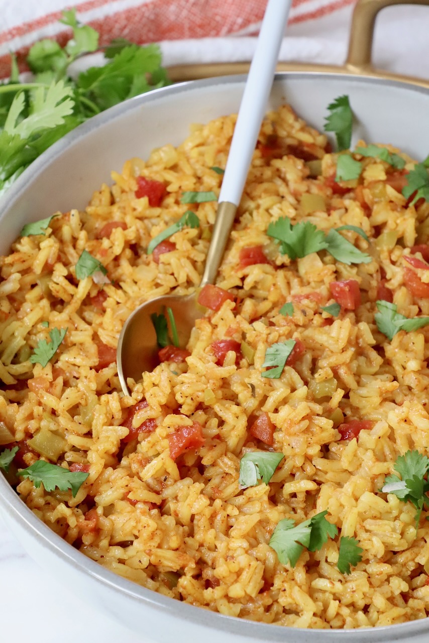 yellow rice in a bowl with a spoon