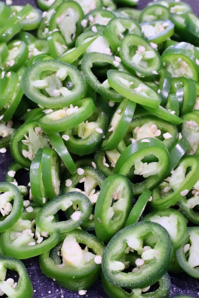 sliced jalapenos on a cutting board