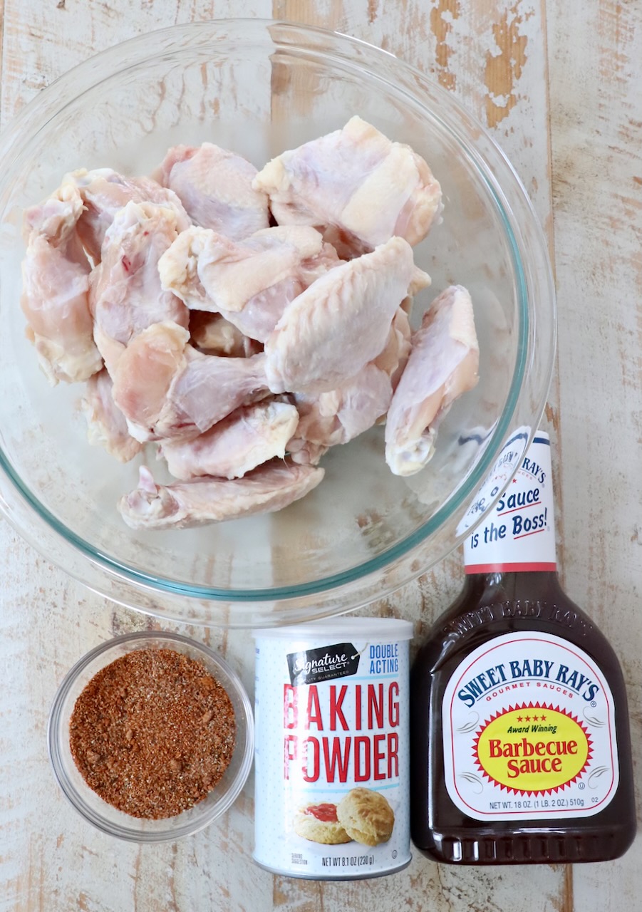 ingredients for bbq chicken wings on a white wood board