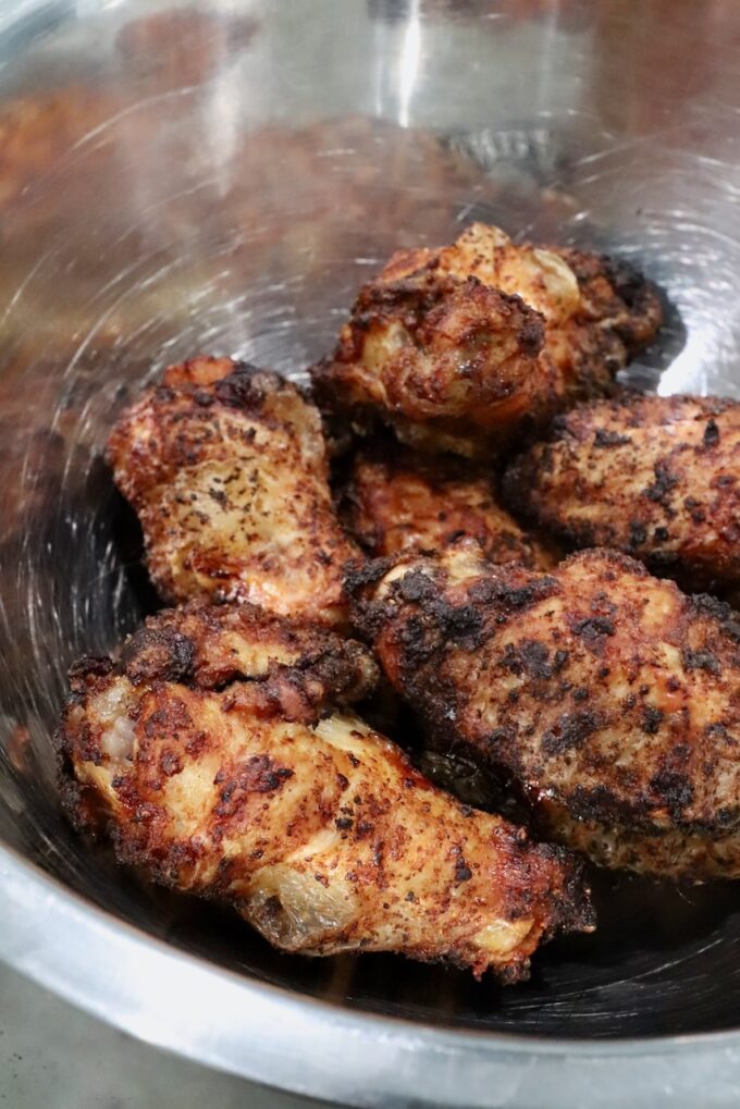 seasoned cooked chicken wings in a metal bowl