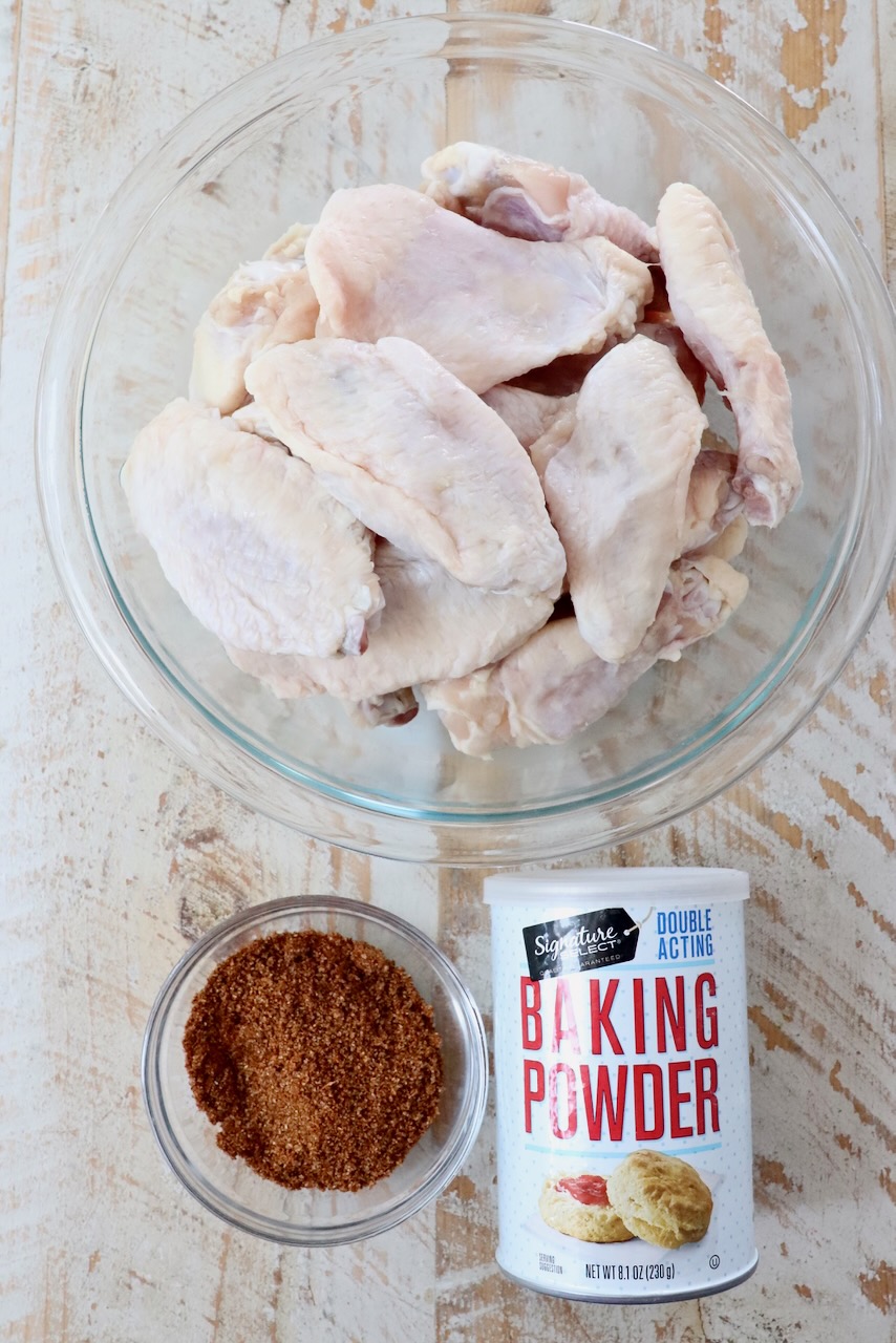 ingredients for cajun wings on a white wood board