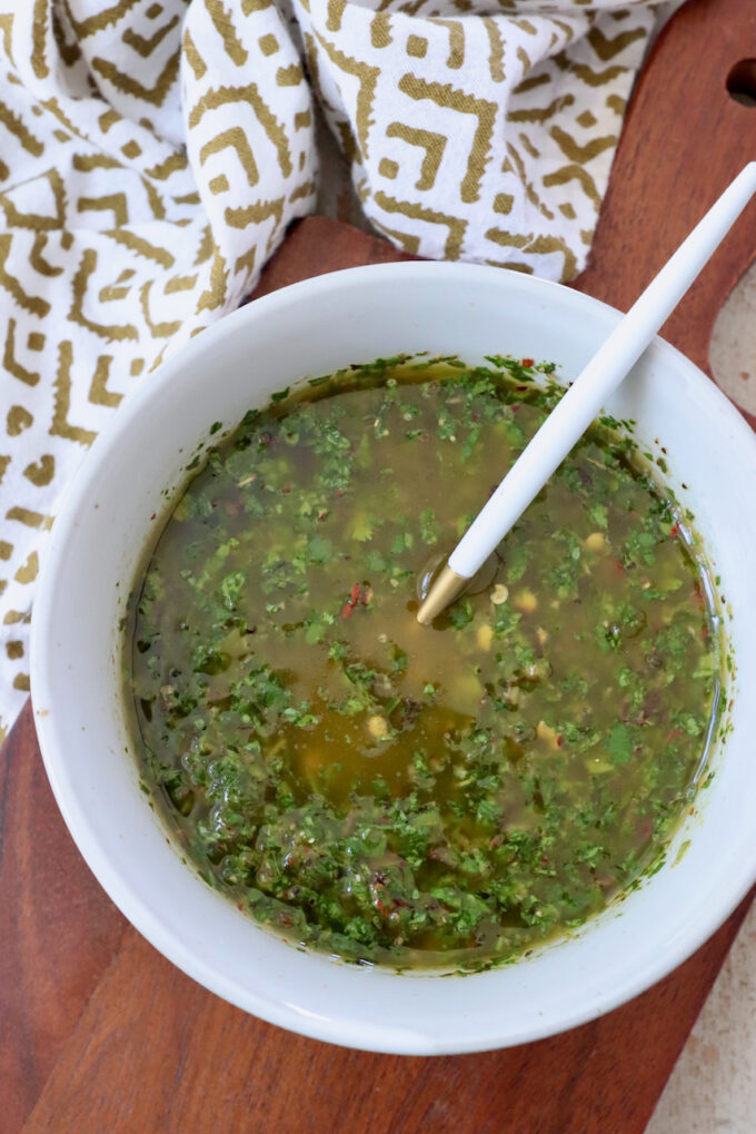 cilantro chimichurri sauce in a bowl with a spoon
