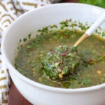 cilantro chimichurri sauce in a bowl with a spoon