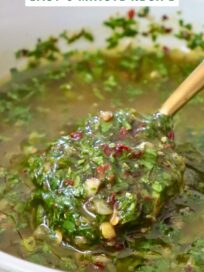 cilantro chimichurri sauce in a bowl with a spoon