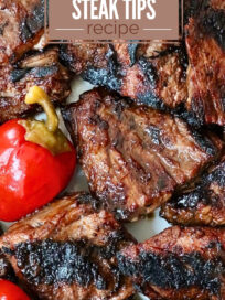 grilled steak tips on a plate with cherry peppers