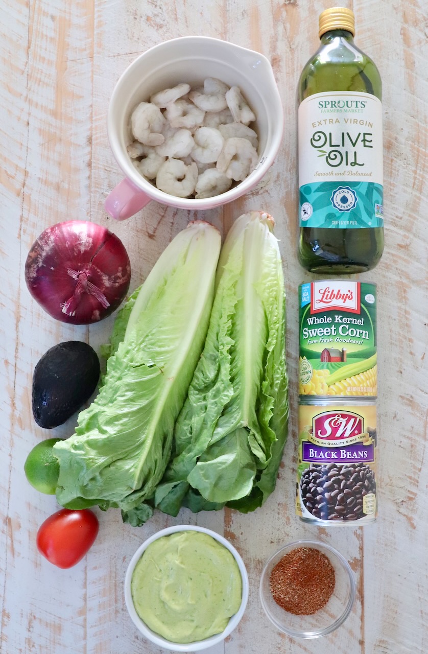 ingredients for Mexican shrimp salad on a white wood board